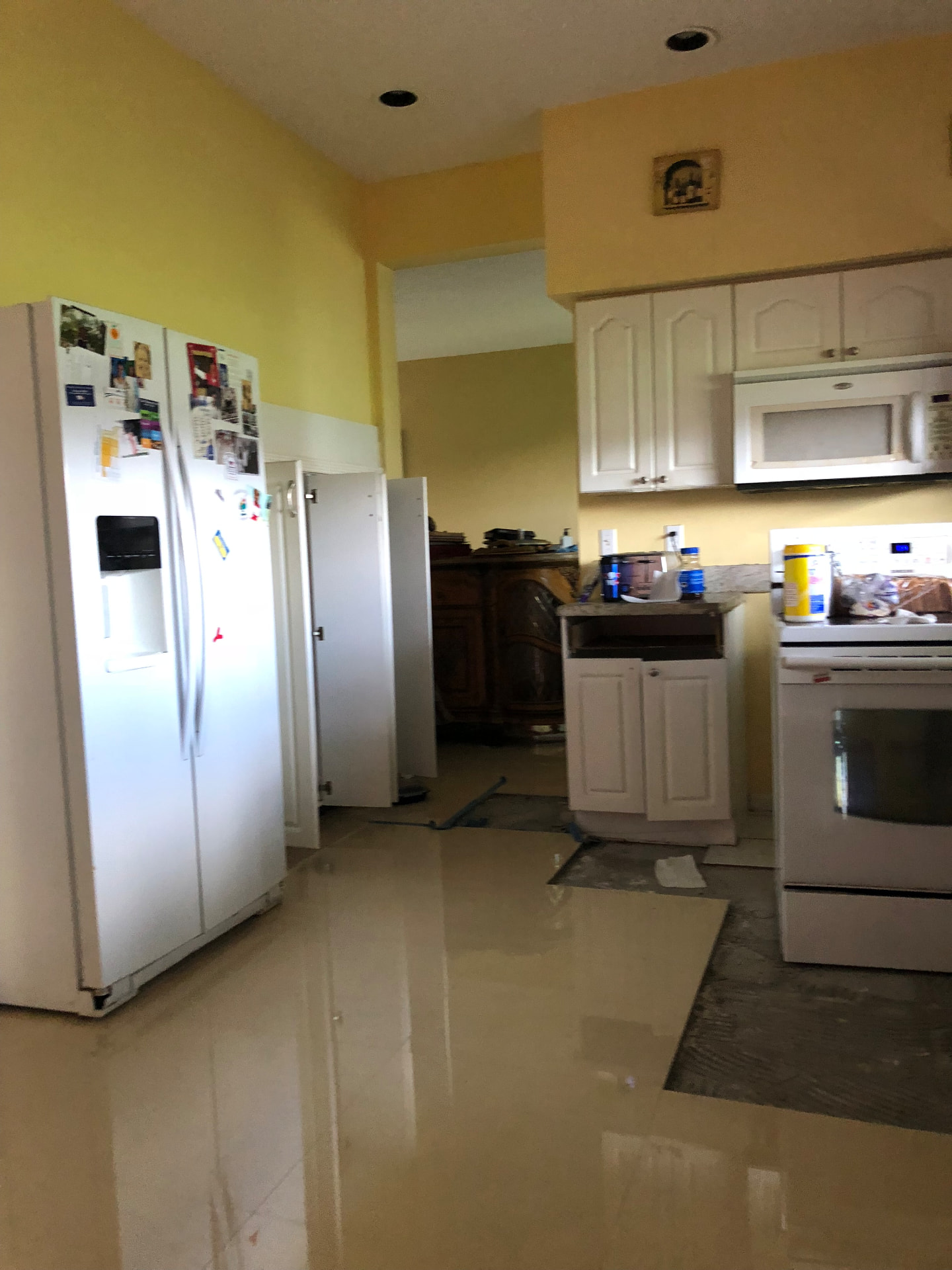 Existing kitchen before remodeling showing demolition of base cabinets and flooring