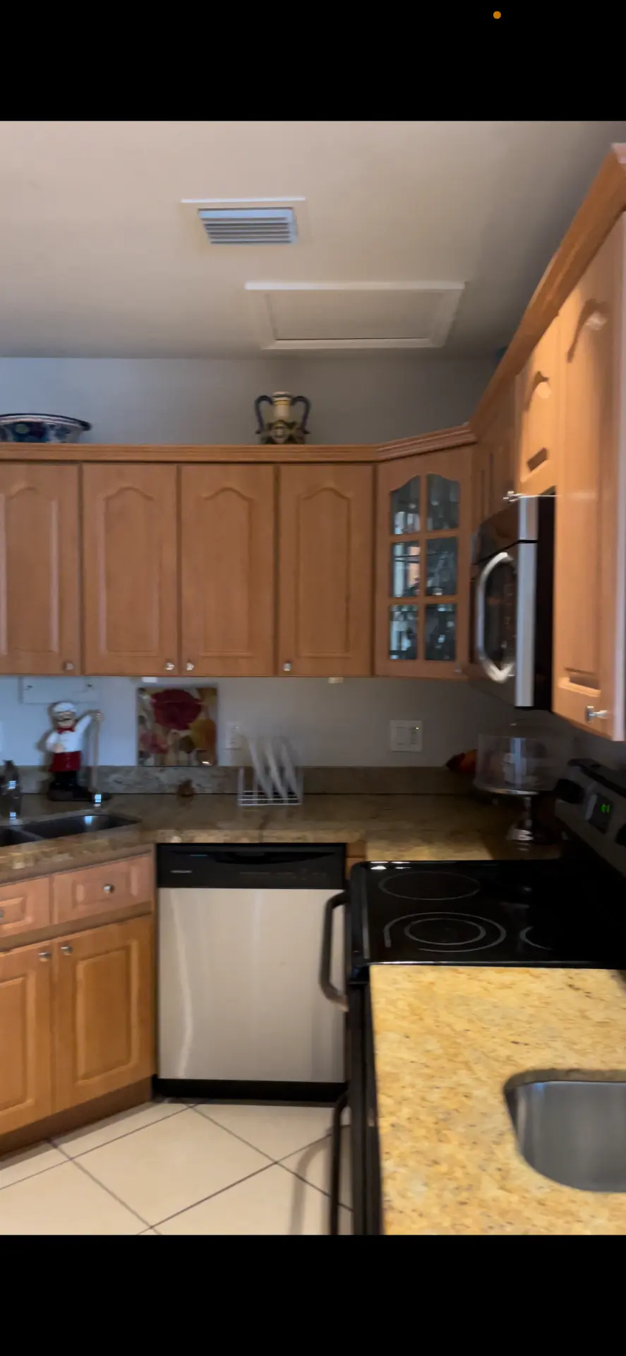 Existing North Miami Beach kitchen before remodeling with maple cabinetry, granite counters and tile floor