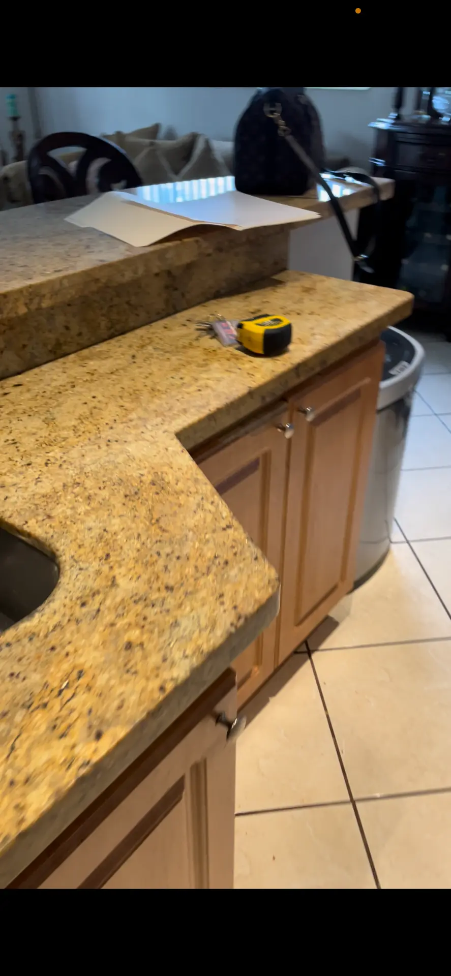 Existing granite peninsula and raised bar counter before kitchen remodeling