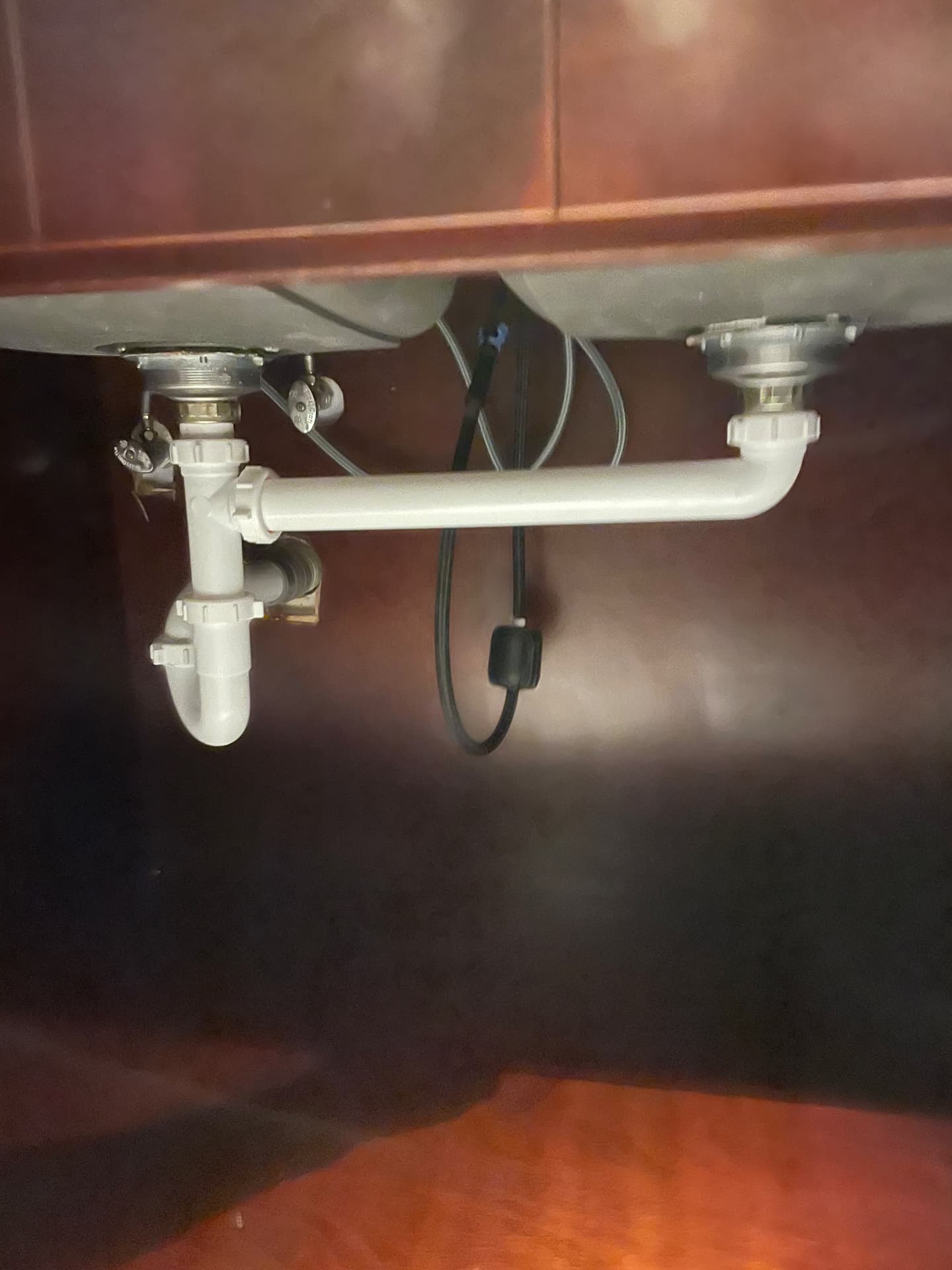 New under-sink plumbing with P-trap and shutoff valves installed during the build